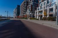 empty city street with two tall apartment buildings in the background on an autumn day's day