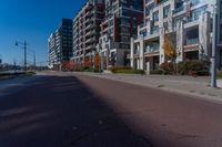 empty city street with two tall apartment buildings in the background on an autumn day's day