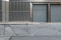 two commercial garages on a city street with the doors open and closed for business