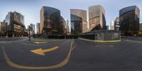 a panorama of a wide city street at sunset with an arrow pointing toward the corner