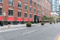 a bike is parked next to a street lined with tall red buildings and windows and a traffic signal