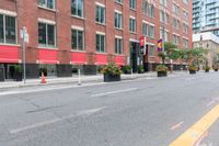 a bike is parked next to a street lined with tall red buildings and windows and a traffic signal