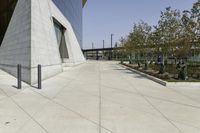 the sidewalk is lined with planter boxes, shrubs and walkways in front of the building