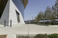 the sidewalk is lined with planter boxes, shrubs and walkways in front of the building