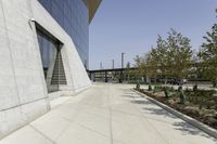 the sidewalk is lined with planter boxes, shrubs and walkways in front of the building