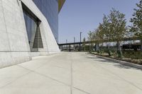 the sidewalk is lined with planter boxes, shrubs and walkways in front of the building