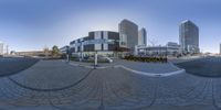 an angle shot of a circular object taken from inside of a fisheye lens, with buildings on both sides of the mirror