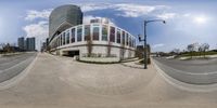 an image of a 360 degrees view of buildings from across the street as seen in a fish eye lens