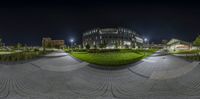 a photo taken with a fish - eye lens that is turned upside down to show a large building and grass