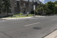 a city street with two stone buildings next to it and a stop sign in front