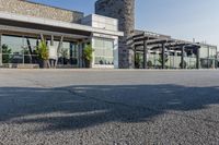 the exterior of an airport with large windows and a fire hydrant in the parking lot