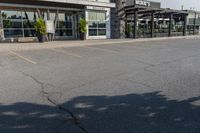 the exterior of an airport with large windows and a fire hydrant in the parking lot