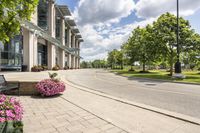 this city street looks like a deserted country side town center with many plants and flowers