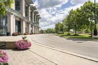 this city street looks like a deserted country side town center with many plants and flowers