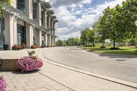 this city street looks like a deserted country side town center with many plants and flowers