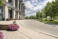 this city street looks like a deserted country side town center with many plants and flowers