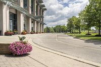 this city street looks like a deserted country side town center with many plants and flowers