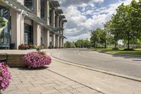 this city street looks like a deserted country side town center with many plants and flowers