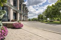 this city street looks like a deserted country side town center with many plants and flowers