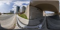 a 360 - fisheye view of some buildings next to a highway and street lights