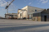 a building with a lot of construction equipment near it's entrance in an industrial area