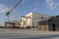 a building with a lot of construction equipment near it's entrance in an industrial area