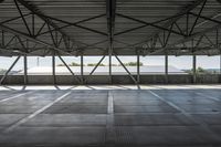 empty empty concrete space with metal ceiling and windows in the airy interior of an industrial building