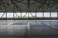 empty empty concrete space with metal ceiling and windows in the airy interior of an industrial building