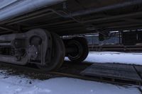 closeup view of some of the wheels on the side of a train on tracks