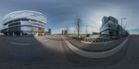 a fisheye lens shows the architecture and the street with traffic lights in front of it