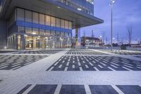 a modern building with glass doors and windows on it's exterior, as well as a black and white geometric pattern