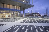 a modern building with glass doors and windows on it's exterior, as well as a black and white geometric pattern