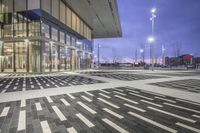 a modern building with glass doors and windows on it's exterior, as well as a black and white geometric pattern