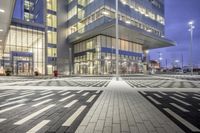 a modern building with glass doors and windows on it's exterior, as well as a black and white geometric pattern