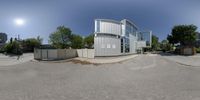 the camera is panoramically showing a modern building that appears to be a large library on the corner