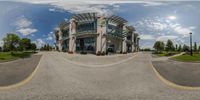 the reflection of a city park in the mirror of a fish eye view of a shopping center