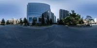 a street that has several buildings in it as seen in a fish eye lens from a fisheye lens