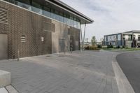 a building has some doors on the side and it is mostly bricked up there are two brown buildings