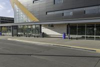 two people are riding their bikes in front of the building and waiting for their turn