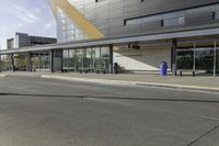 two people are riding their bikes in front of the building and waiting for their turn