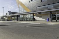 two people are riding their bikes in front of the building and waiting for their turn