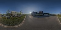 a 360 - view of cars parked on the street at dusk and sun peeking over the buildings