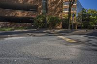 a stop sign on a city street by tall buildings in a city area of an urban setting