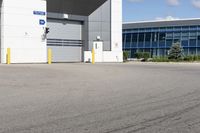 a parking lot in front of a large commercial building with a small motorcycle parked near it