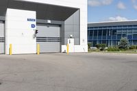 a parking lot in front of a large commercial building with a small motorcycle parked near it