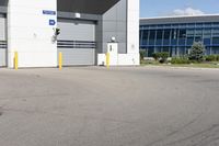 a parking lot in front of a large commercial building with a small motorcycle parked near it