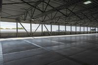 the interior of a warehouse building with metal mesh coverings and a concrete floor and walkway