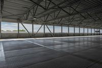 the interior of a warehouse building with metal mesh coverings and a concrete floor and walkway