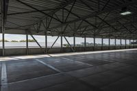 the interior of a warehouse building with metal mesh coverings and a concrete floor and walkway