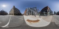 a 360 view looking up at buildings at the intersection of a street corner with some buildings around it